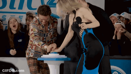 Woman In Blue Dress Pressing Button Man In Plaid Shirt Looking On GIF