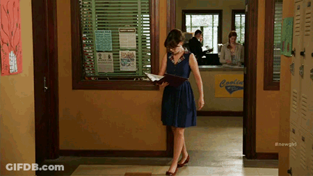 Woman In Blue Dress Reading Book In Hallway GIF
