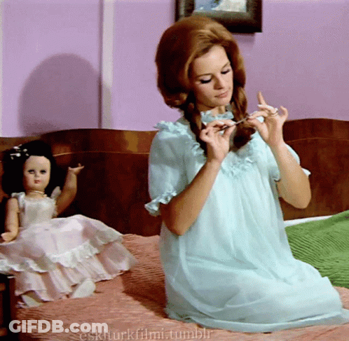 Woman In Blue Dress Sits On Bed Next To Doll Eskiturkfilmi.tumblr GIF