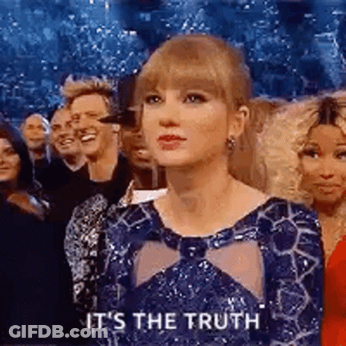 Woman In Blue Dress Sitting Before Crowd GIF