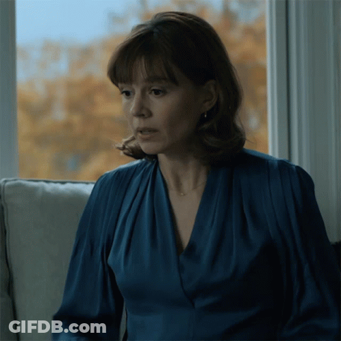 Woman In Blue Dress Sitting On Couch GIF