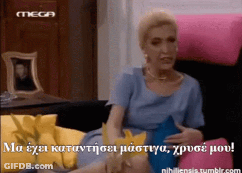 Woman In Blue Dress Sitting On Pink Couch With Mega Logo GIF