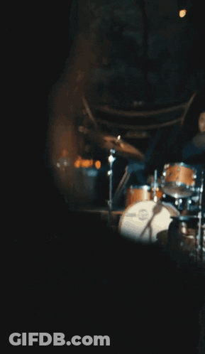 Woman In Blue Dress Sitting On Stool GIF