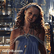 Woman In Blue Dress Smiling At Night City GIF