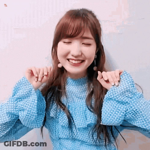 Woman In Blue Dress Smiling With Eyes Closed And Hands On Neck GIF