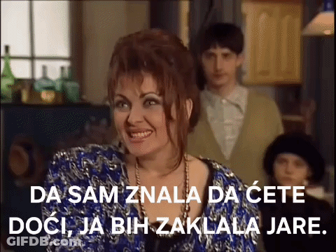 Woman In Blue Dress Smiling With Man In Suit GIF