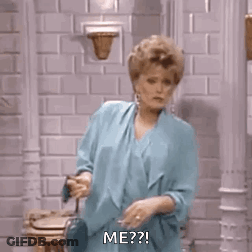 Woman In Blue Dress Smoking Cigarette By Brick Wall GIF