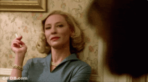 Woman In Blue Dress Smoking Cigarette GIF