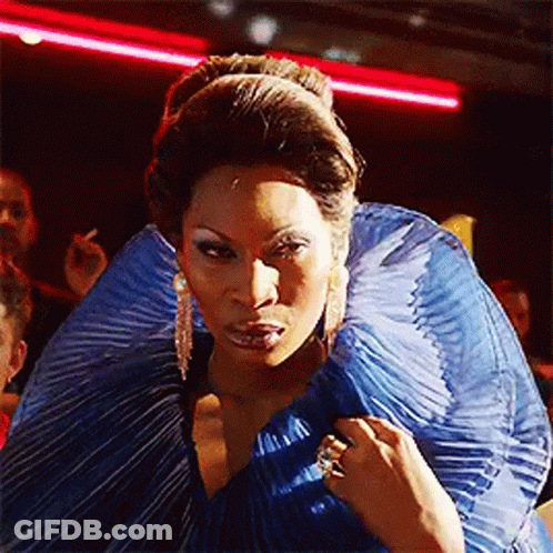 Woman In Blue Dress Standing Before Crowd GIF