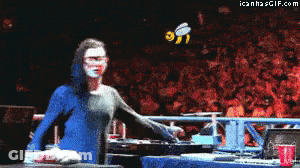 Woman In Blue Dress Standing Before Crowd With Bee GIF