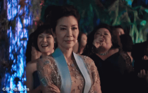 Woman In Blue Dress Standing In Crowd GIF