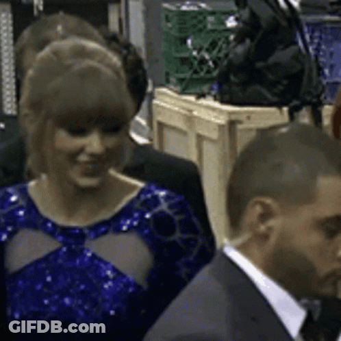 Woman In Blue Dress Standing In Crowd GIF