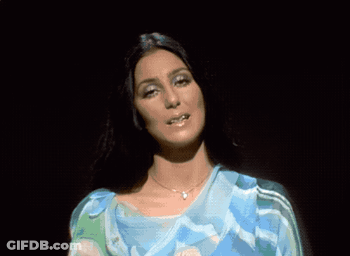 Woman In Blue Dress Standing In Front Of Crowd GIF