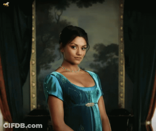 Woman In Blue Dress Standing In Front Of Picture GIF