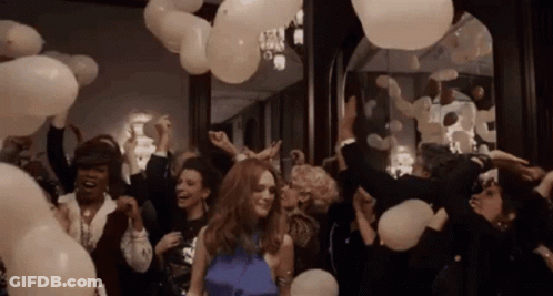 Woman In Blue Dress Surrounded By Balloons GIF