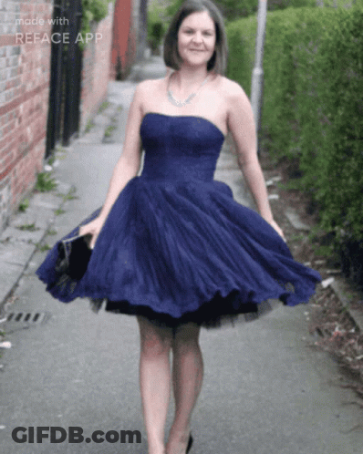 Woman In Blue Dress Walking Down Street GIF