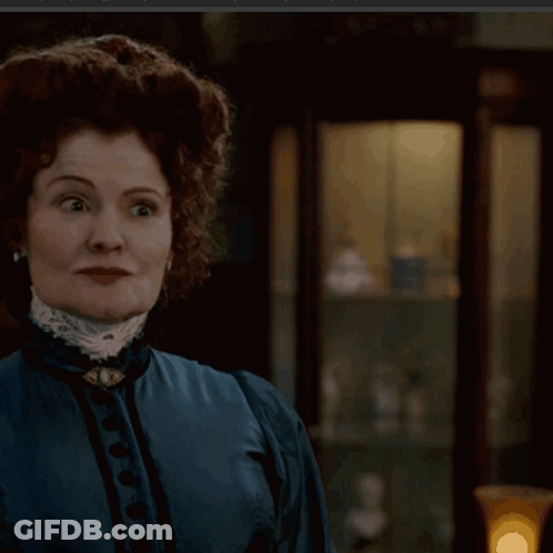 Woman In Blue Dress With Brooch GIF
