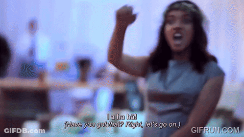 Woman In Blue Dress With Flower Crown Saying La Ha Ha GIF