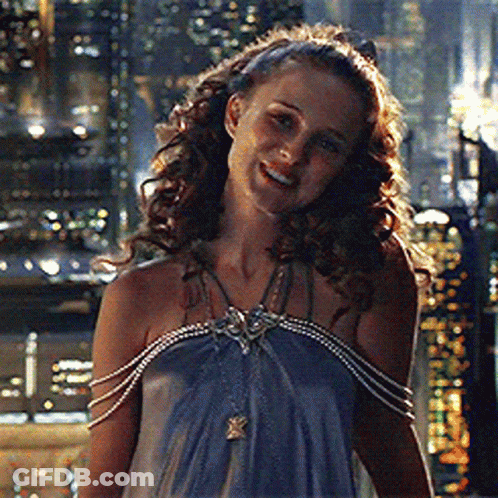 Woman In Blue Dress With Pearl Sleeves Smiling GIF
