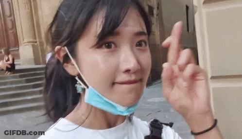 Woman In Blue Face Mask Making Peace Sign GIF
