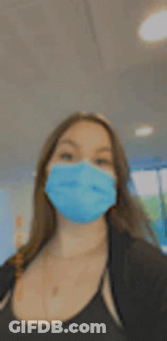 Woman In Blue Face Mask Taking Selfie GIF