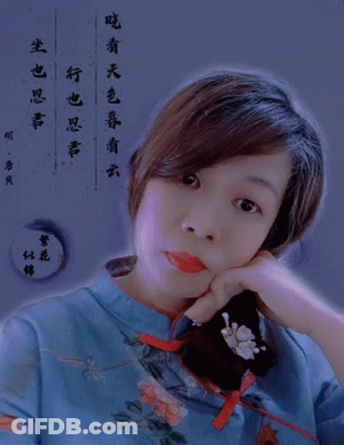 Woman In Blue Floral Shirt Looking At Camera GIF