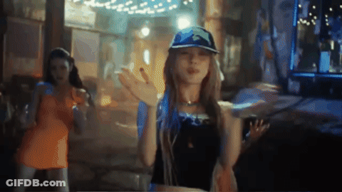 Woman In Blue Hat Dancing In Dark Room GIF