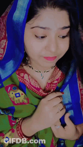 Woman In Blue Head Scarf And Green And Pink Dress GIF