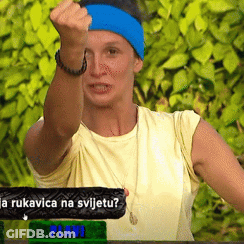 Woman In Blue Headband Holding Fist Up In Front Of Plavi Sign GIF