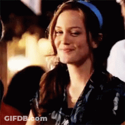 Woman In Blue Headband Smiling At Camera GIF