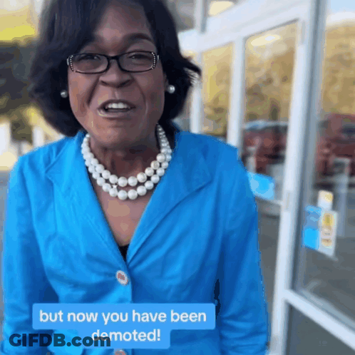 Woman In Blue Jacket And Pearls Says But Now You Have Been Demoted GIF