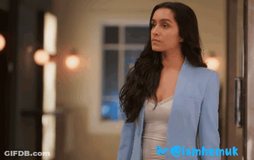 Woman In Blue Jacket At Window With Twitter Logo GIF