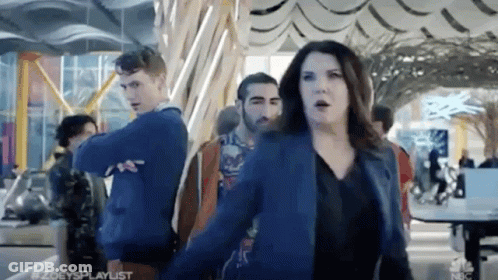 Woman In Blue Jacket Dancing Before Crowd GIF