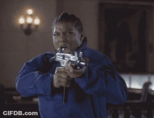 Woman In Blue Jacket Holding Flaming Gun GIF
