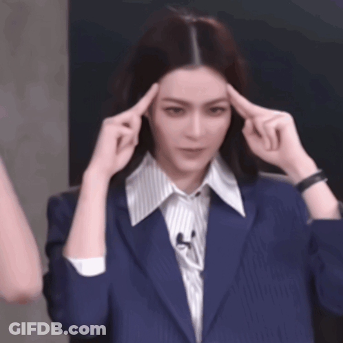 Woman In Blue Jacket Holding Hands To Head GIF