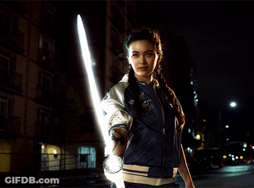 Woman In Blue Jacket Holding Light Saber GIF
