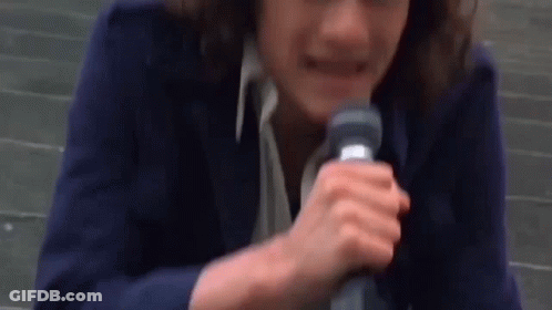 Woman In Blue Jacket Holding Microphone GIF