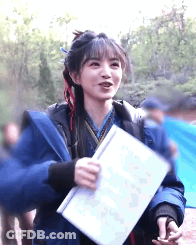 Woman In Blue Jacket Holding Paper GIF
