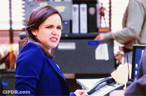 Woman In Blue Jacket Holding Phone GIF