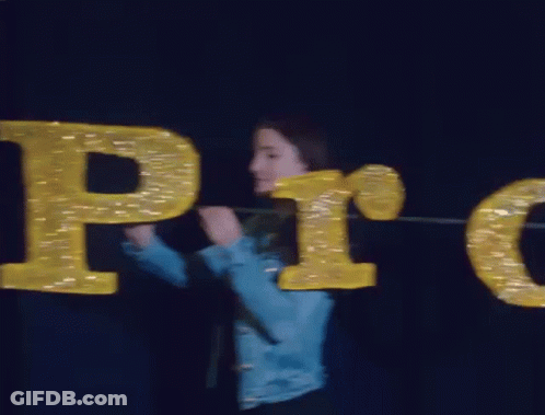 Woman In Blue Jacket Holding Pro Sign GIF