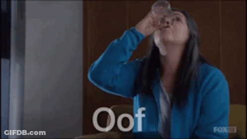 Woman In Blue Jacket Holding Water Glass GIF