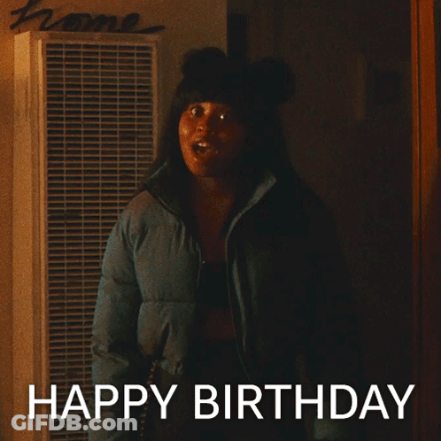 Woman In Blue Jacket In Front Of Home Sign GIF