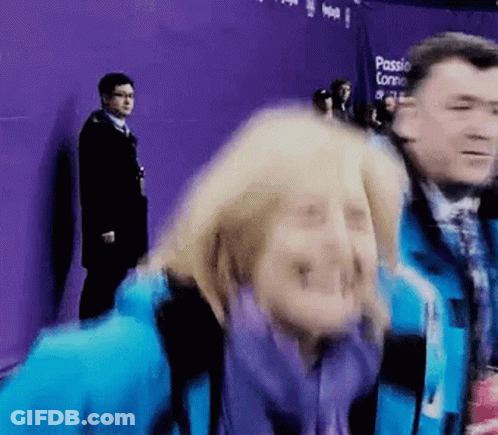 Woman In Blue Jacket Making Funny Face, Man Behind GIF