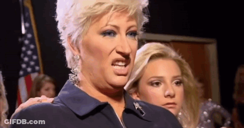 Woman In Blue Jacket Making Funny Face GIF