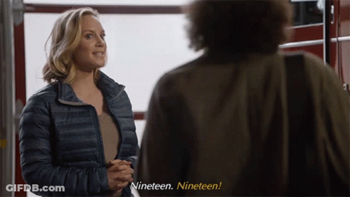 Woman In Blue Jacket Man Saying Nineteen Nineteen GIF