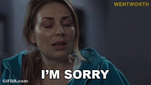 Woman In Blue Jacket Saying I'm Sorry At Wentworth Sign GIF