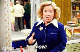 Woman In Blue Jacket Says Pow GIF