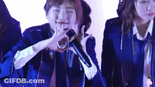 Woman In Blue Jacket Singing Into Microphone GIF