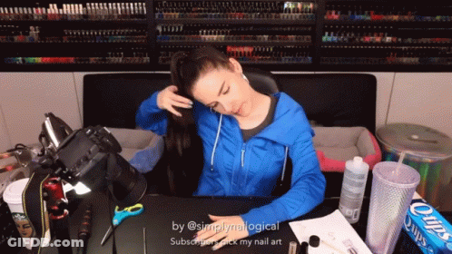 Woman In Blue Jacket Sitting At Desk With Chips GIF