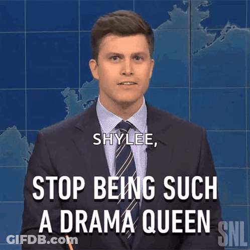 Woman In Blue Jacket Talking At Counter GIF